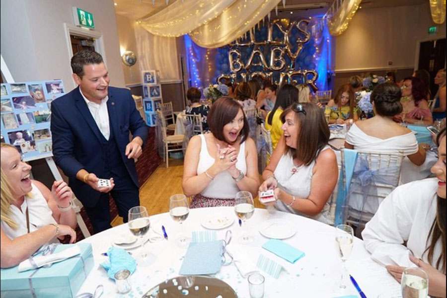 Francis Moore Magician performing at baby shower